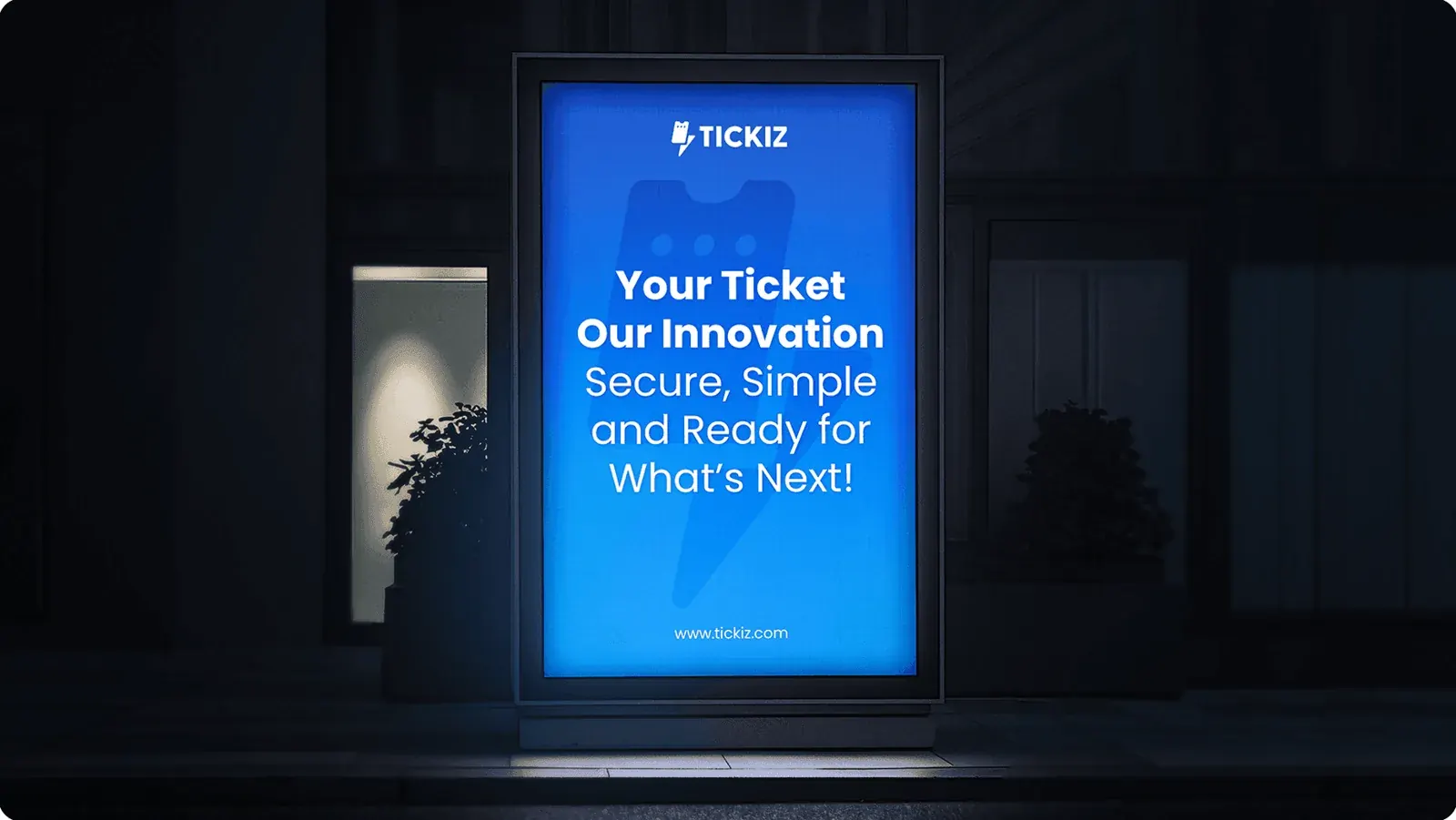 A backlit TICKIZ poster in a street lightbox