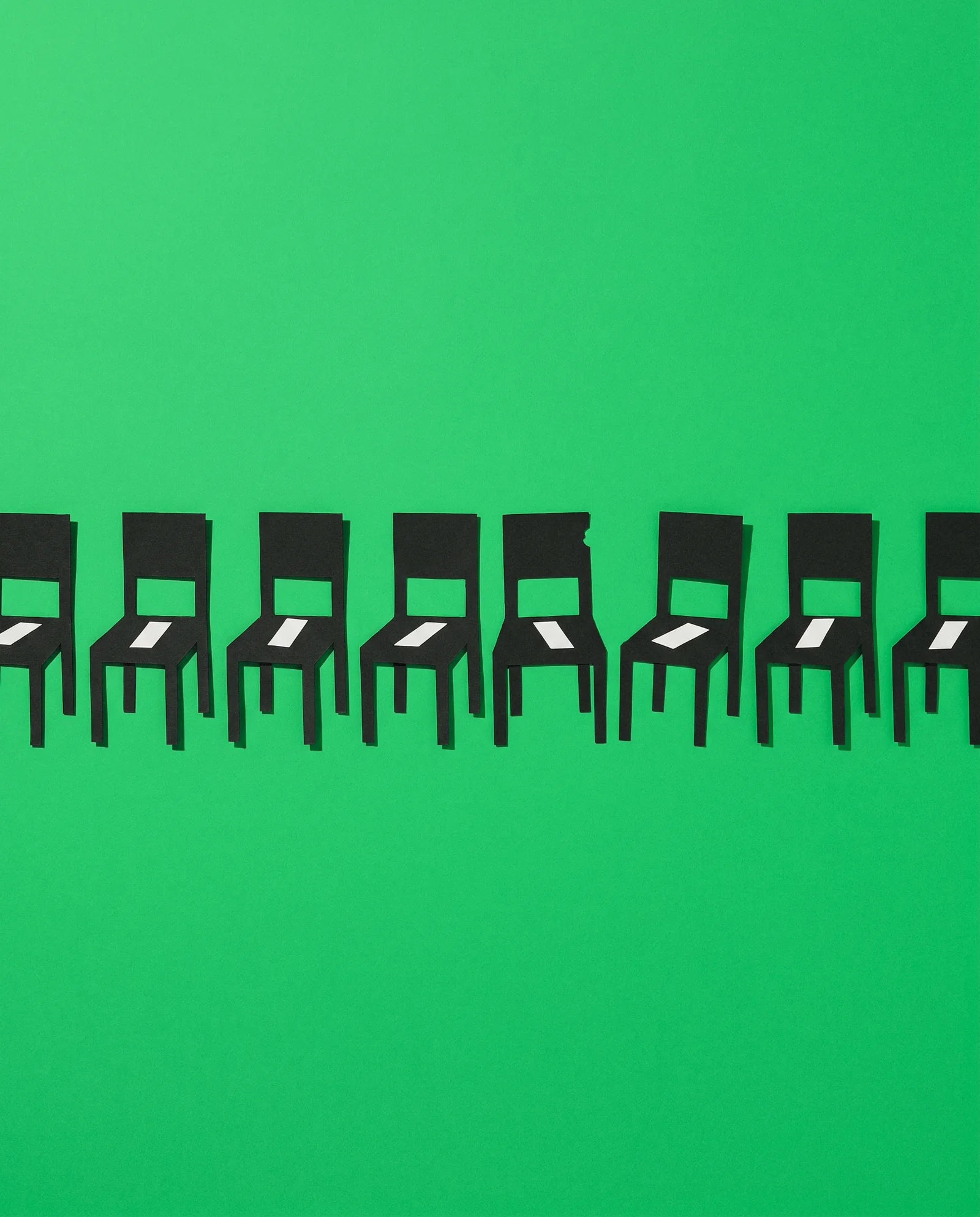 Paper-cutout dental chairs in a row, every one filled