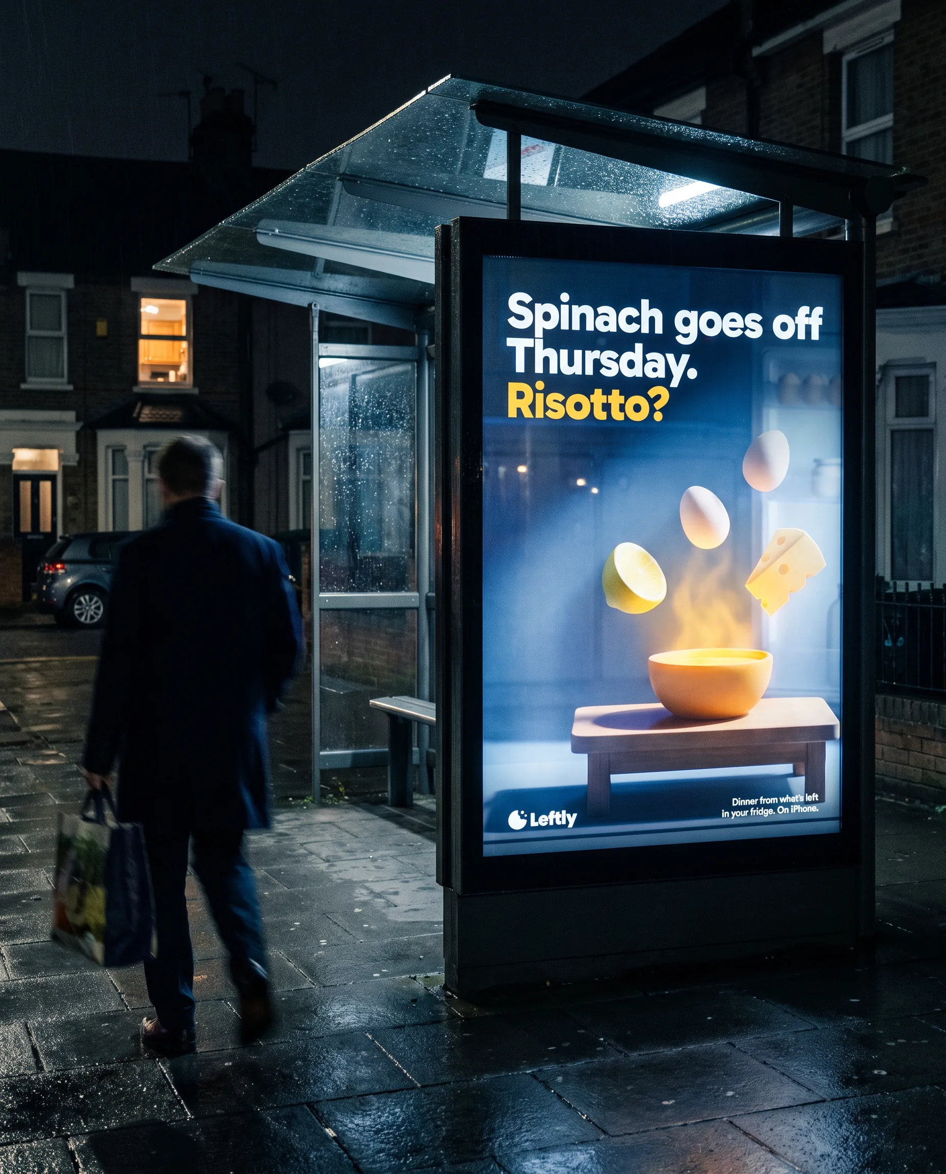A Leftly poster lit in a bus shelter at night: Spinach goes off Thursday. Risotto?