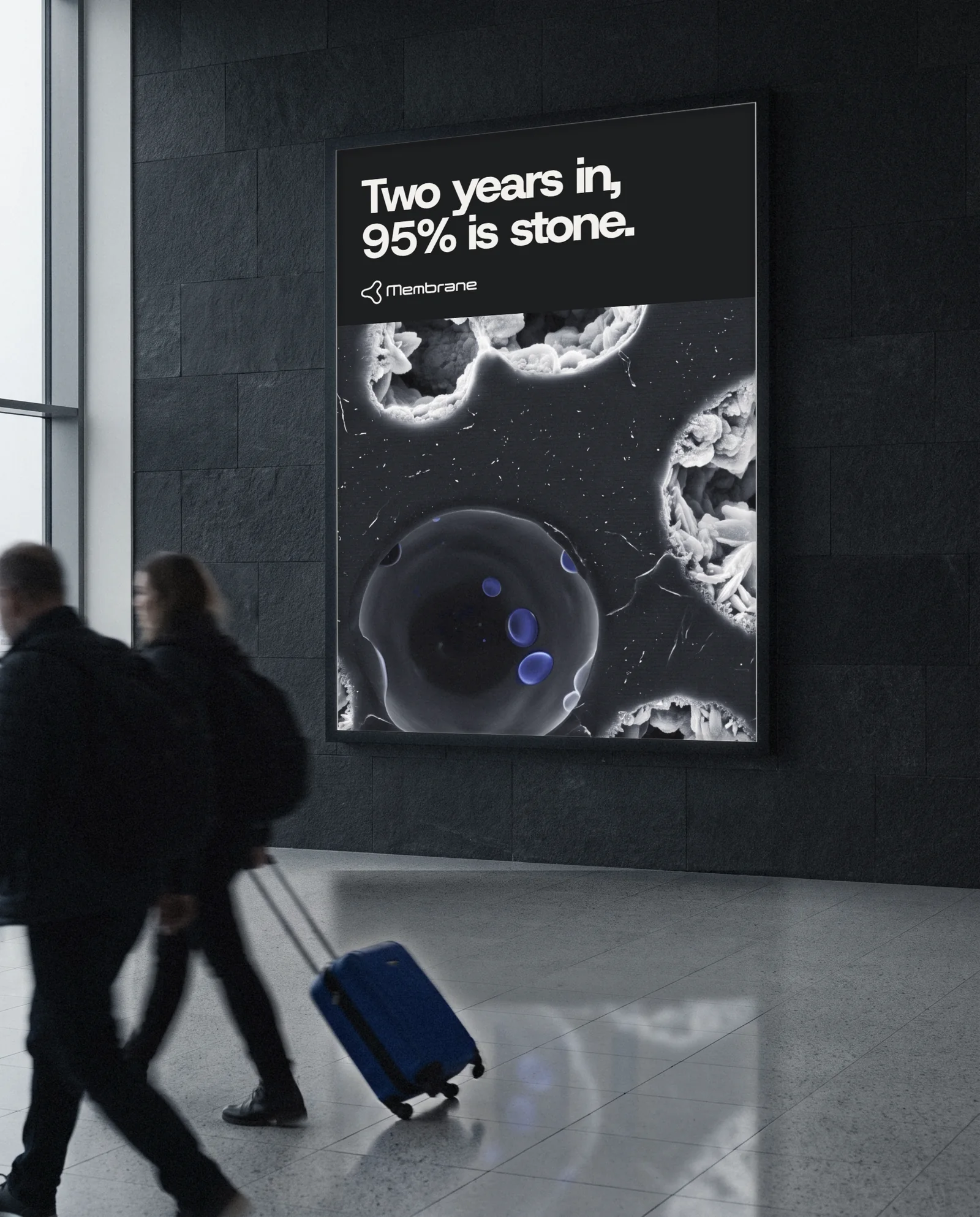 A Membrane ad in an airport arrivals lightbox: two years in, 95% is stone