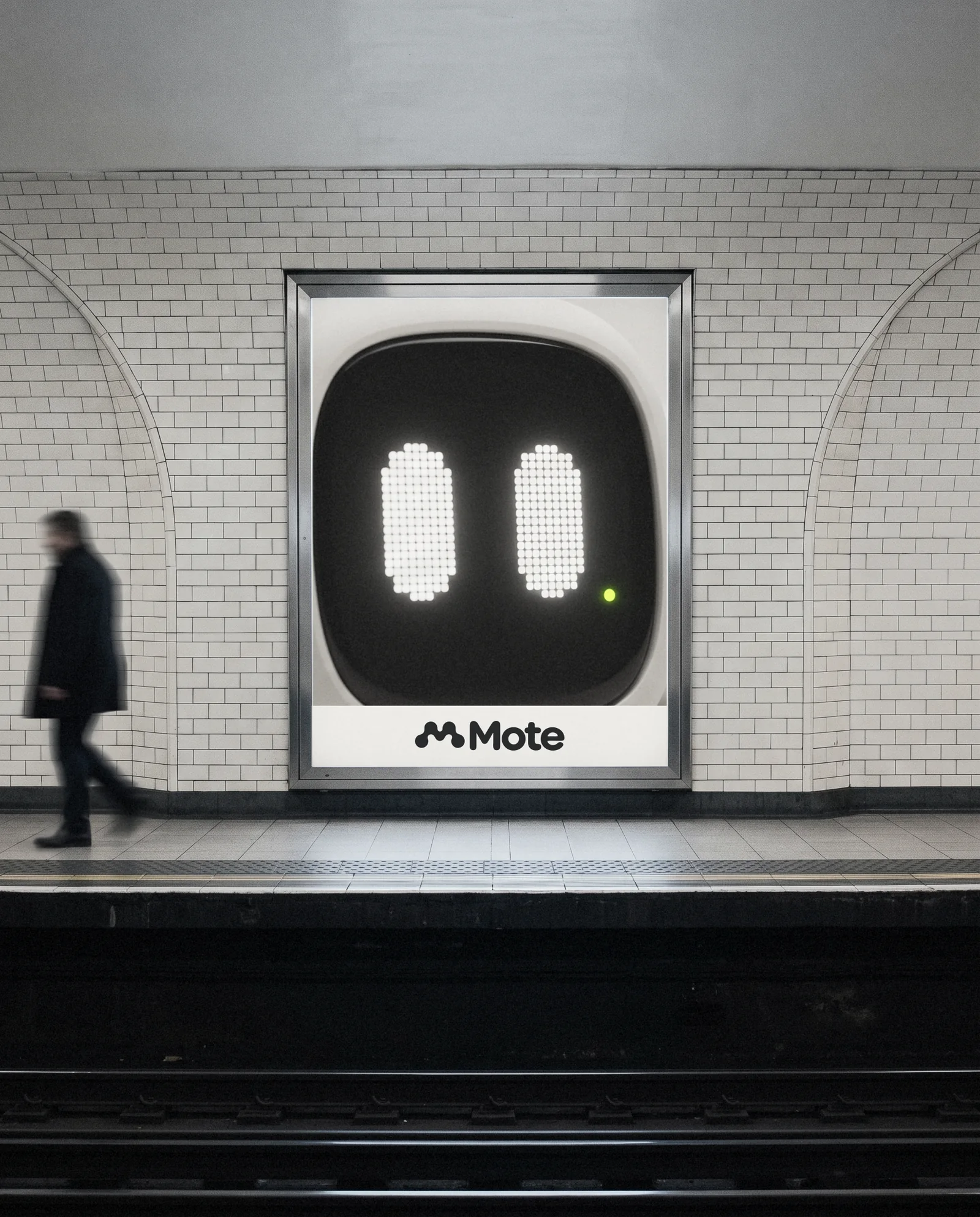 A Mote poster in a metro lightbox: one giant pair of pixel eyes